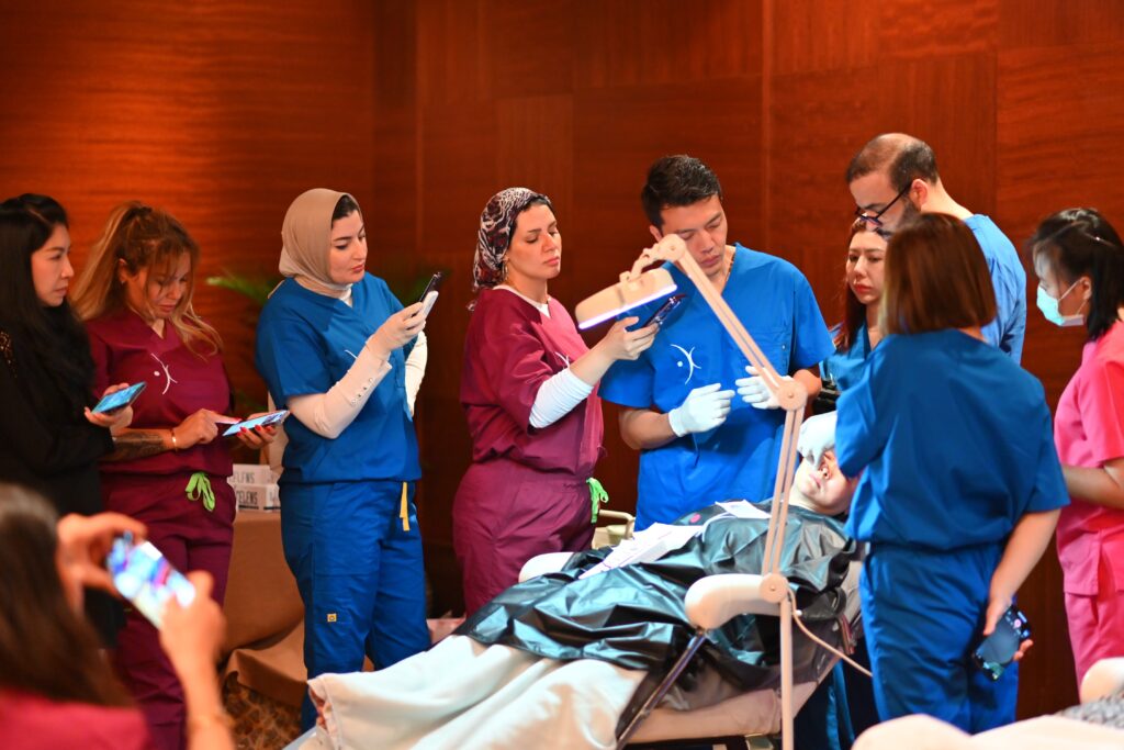 Doctors attending the Global Experts Academy Anti-Aging Master Course in Tbilisi, Georgia, observing a live injection demonstration